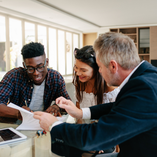 Investor couple discussing contract with real estate agent.